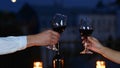 Close up of young Caucasian happy couple celebrating anniversary at romantic date in evening on rooftop. Beautiful man Royalty Free Stock Photo