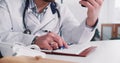 Close-up young Caucasian male doctor consulting remote patient using smart phone web conference, taking notes at office. Royalty Free Stock Photo