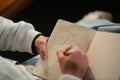 Close-up of young Caucasian man taking notes in notepad Royalty Free Stock Photo