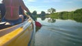 CLOSE UP: Young man and woman paddle a canoe down a calm river in Slovenia. Royalty Free Stock Photo