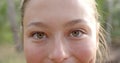 Close-up of a young Caucasian woman with hazel eyes and a subtle smile