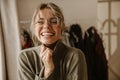 Close-up young caucasian woman laughing hard while screwing up eyes while being indoors. Royalty Free Stock Photo