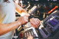 Close-up of a young Caucasian woman`s hand in the gym uses a sports watch, a black pulse wrist on the back of a treadmill in a sp Royalty Free Stock Photo