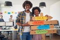 Close-up of young cheerful colleagues posing for a photo and promoting company slogans in the office. Employees, job, office Royalty Free Stock Photo