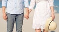 Close-up of a young couple enjoying the sunset in the dunes holding hands. Romantic traveler walks through the desert Royalty Free Stock Photo