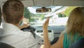 CLOSE UP: Young couple fights in the car while cruising through the suburbs. Royalty Free Stock Photo