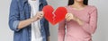 Close up of young couple holding red broken heart Royalty Free Stock Photo