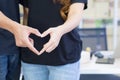 Close-up of a young couple making a heart shape with hands. Space for text. Concept of celebrating Valentine`s Day Royalty Free Stock Photo