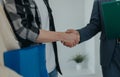 Close-up of young couple shaking hands with real estate agent when buying their new home. Royalty Free Stock Photo