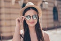 Close up of young cute smiling girl in mirror sunglasses and hat