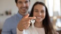 Young excited couple showing keys in hands to camera. Royalty Free Stock Photo