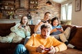 Young family playing video games together in the living room on a gaming console Royalty Free Stock Photo