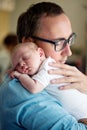 Close up of young father holding his newborn baby son Royalty Free Stock Photo