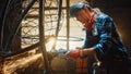 Close Up of Young Female Fabricator in Safety Mask. She is Grinding a Metal Tube Sculpture with an