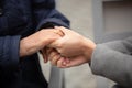 Close-up of young female hands holding senior woman hands Royalty Free Stock Photo