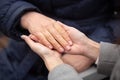 Close-up of young female hands holding senior woman hands Royalty Free Stock Photo