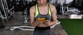 close up young fit woman using smart phone at gym Royalty Free Stock Photo