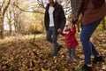 Close Up Of Young Girl On Autumn Walk With Parents Royalty Free Stock Photo