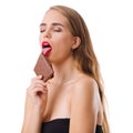 Close-up of a young girl, blonde, with a piece of chocolate in her hands isolated on white background. Royalty Free Stock Photo