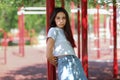 A close-up of a young girl in casual clothes on a blurred athletic field background. Fashion, urban, youth concept. Copy space.