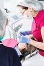 Close-up a young girl in a dentist`s chair undergoes a routine diagnosis after removing braces with cleaning and sizing Royalty Free Stock Photo