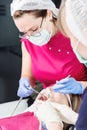 Close-up a young girl in a dentist`s chair undergoes a routine diagnosis after removing braces with cleaning and sizing Royalty Free Stock Photo