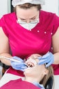 Close-up a young girl in a dentist`s chair undergoes a routine diagnosis after removing braces with cleaning and sizing Royalty Free Stock Photo