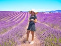 Close up of a young girl in a floral dress with a hat on her head between lavender in southern Provence Valensole France Royalty Free Stock Photo