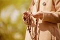 Close up young girl holding rosary and praying to God Royalty Free Stock Photo