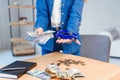 Happy girl in eyeglasses holds a sum of money in one hand and small model of her future car in another hand. Royalty Free Stock Photo