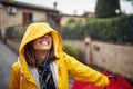 Close-up of a young girl on the street is enjoying rain and listening to the music. Walk, rain, city Royalty Free Stock Photo