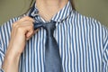 Close up of a young girl in a striped blue shirt and tie, business clothes, an office worker in a suit Royalty Free Stock Photo