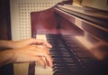 Close up of young girls hands, playing piano. vintage tone filte Royalty Free Stock Photo