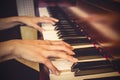 Close up of young girls hands, playing piano. vintage tone filte Royalty Free Stock Photo