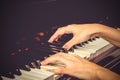 Close up of young girls hands, playing piano. vintage tone filte Royalty Free Stock Photo