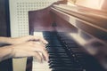 Close up of young girls hands, playing piano. vintage tone filte Royalty Free Stock Photo