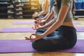 Close up of young hand woman yoga practitioners in group doing yoga in modern fitness class indoor Royalty Free Stock Photo