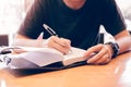 Close up of young hand writing notes in study room. Royalty Free Stock Photo