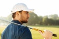 Close up of a young handsome male golfer in hat Royalty Free Stock Photo