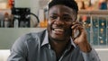 Close-up young happy african american man talking on phone answering friendly call making order in online store Royalty Free Stock Photo