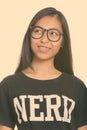 Close up of young happy Asian teenage nerd girl smiling while thinking Royalty Free Stock Photo