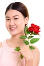 Close up of young happy Asian woman smiling and holding red rose Royalty Free Stock Photo