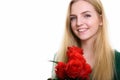 Close up of young happy teenage girl smiling while holding red r Royalty Free Stock Photo