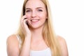 Close up of young happy teenage girl smiling while talking on mo Royalty Free Stock Photo