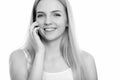Close up of young happy teenage girl smiling while talking on mobile phone Royalty Free Stock Photo
