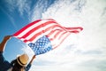 Close up young happy woman holding United States of America flag Royalty Free Stock Photo