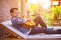 Young hipster man practiced guitar in the park,happy and enjoy playing guitar.