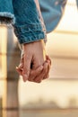 Close up of young lesbian couple holding each other hands, standing together outdoors Royalty Free Stock Photo