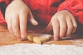 Close up young little chef girl with cook hat and apron preparing sweet desert at home kitchen Royalty Free Stock Photo