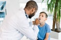 Close-up Of A Young male African Doctor Checking His Patient`s Boy Throat In Clinic Royalty Free Stock Photo